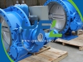 Hydraulic slow closing butterfly check valve with accumulator